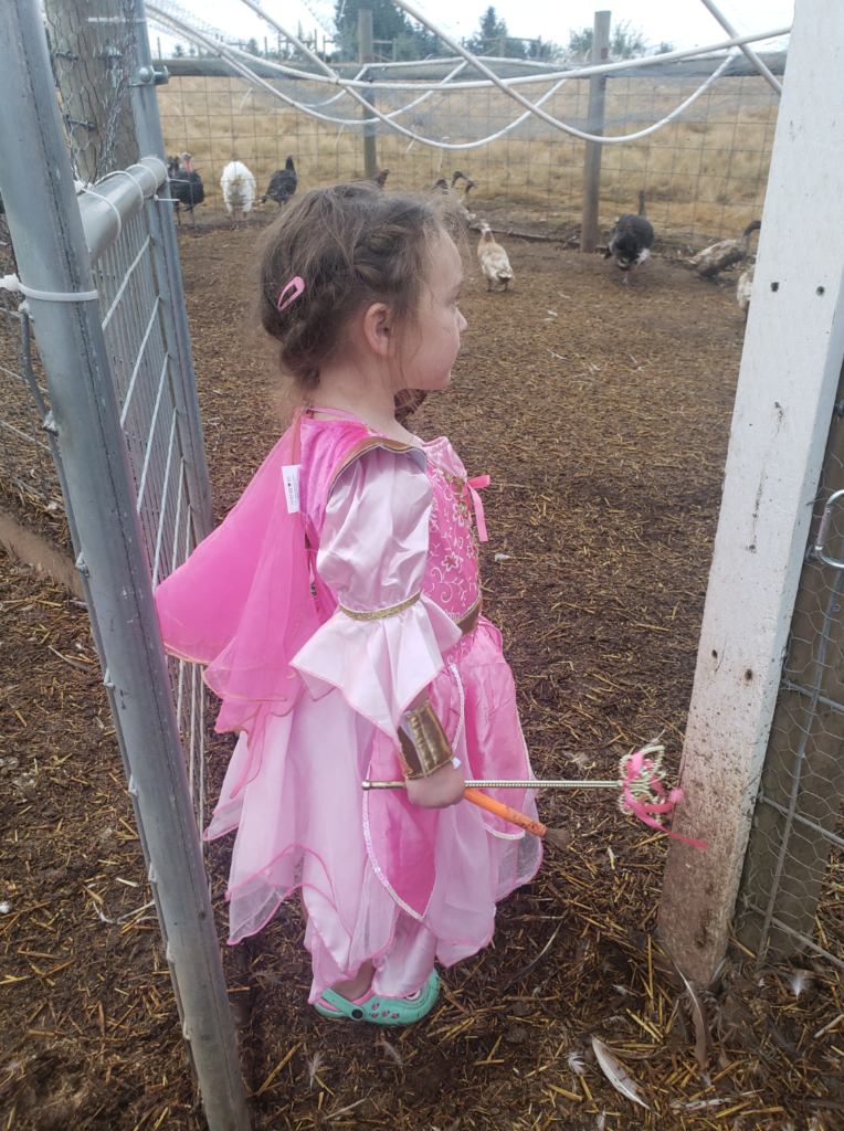 Peyton in princess dress collecting eggs