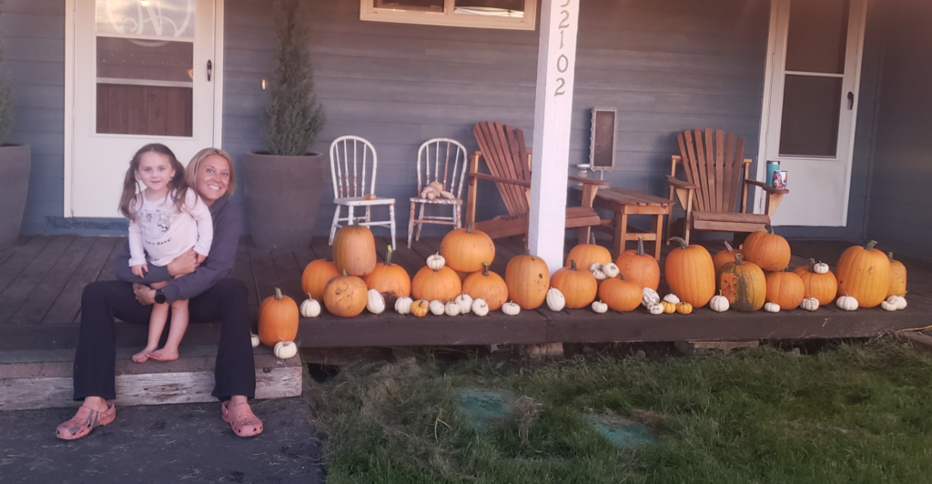 Emily & Peyton on the front steps for their traditional pumpkin harvest picture 