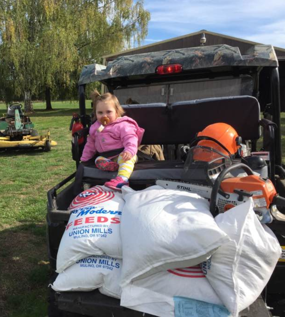 Gator with added seat in the back, loaded with gear & feed