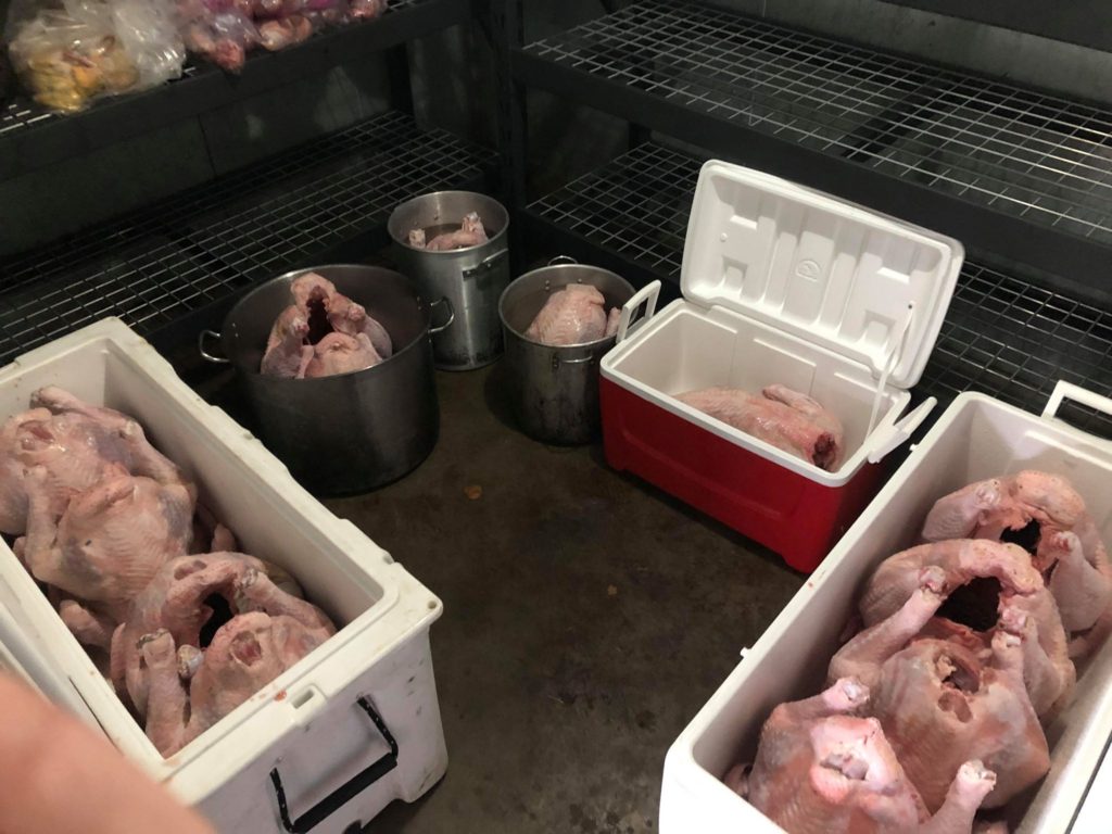 Turkeys getting prepped for brine in the walk-in cooler